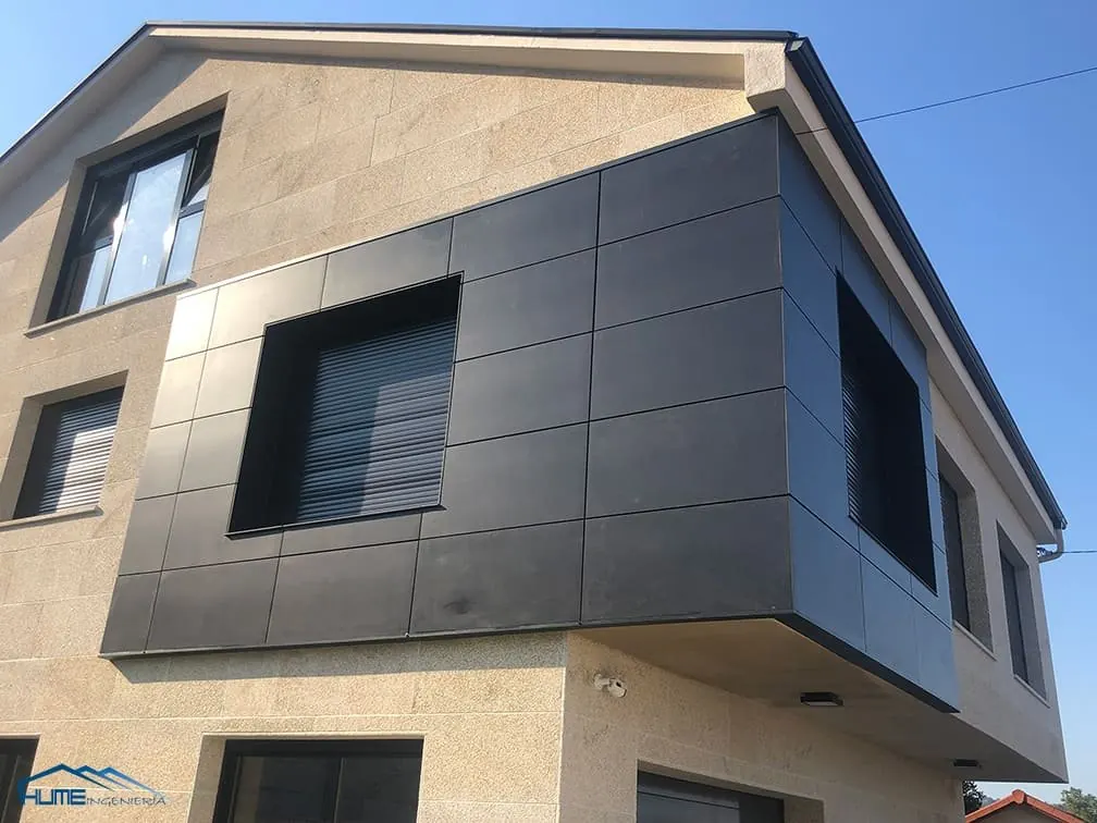 Fachada ventilada con paneles oscuros en una vivienda