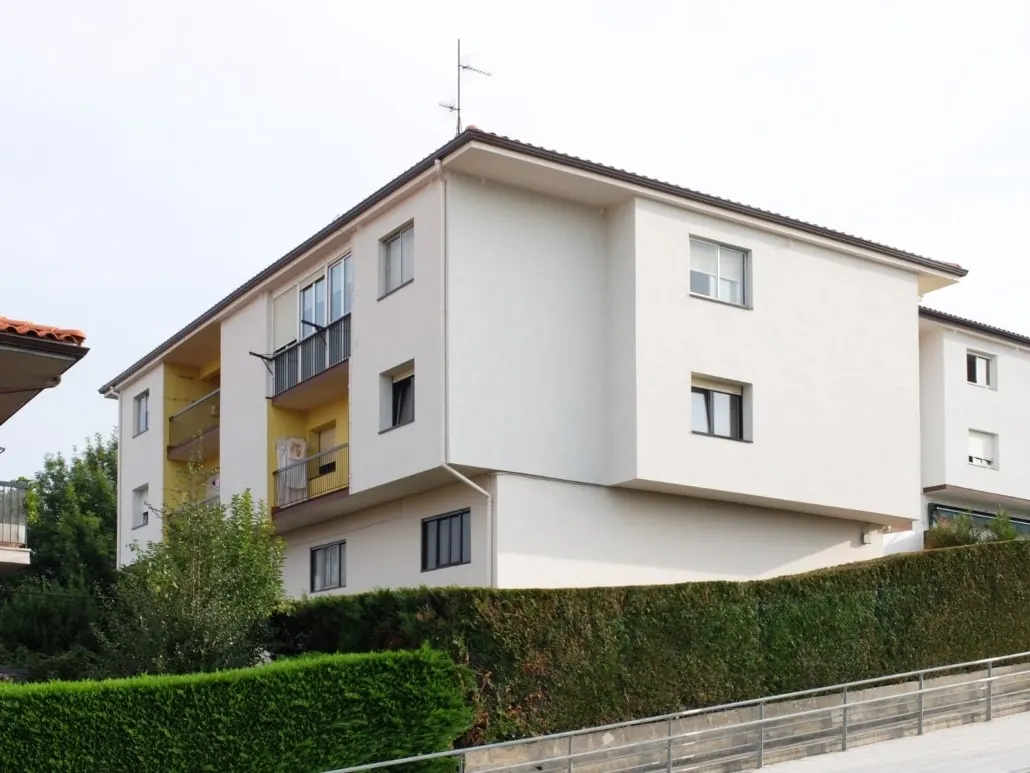 Vivienda con fachada blanca y balcones